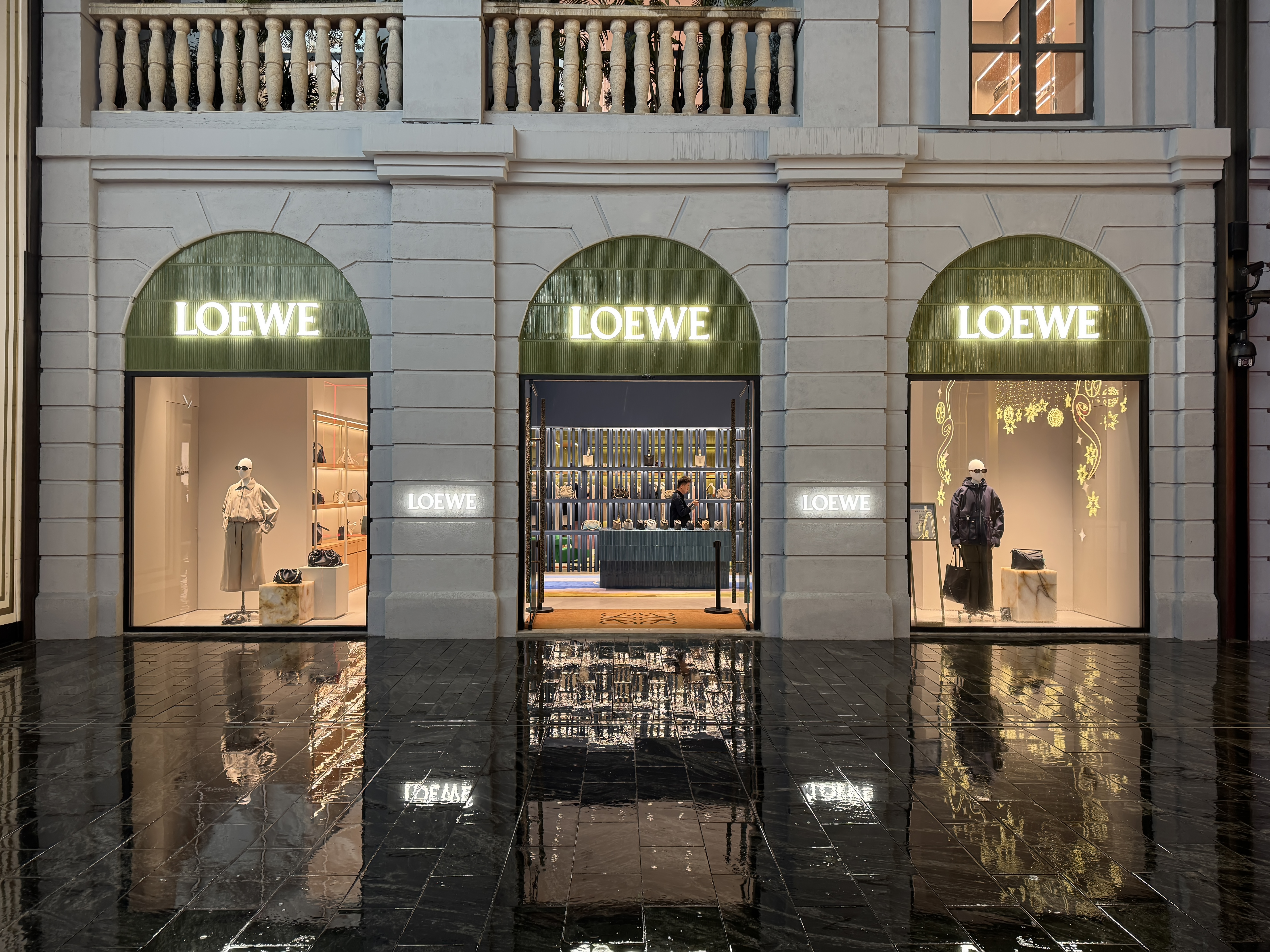 LOEWE storefront — three arched windows at dusk