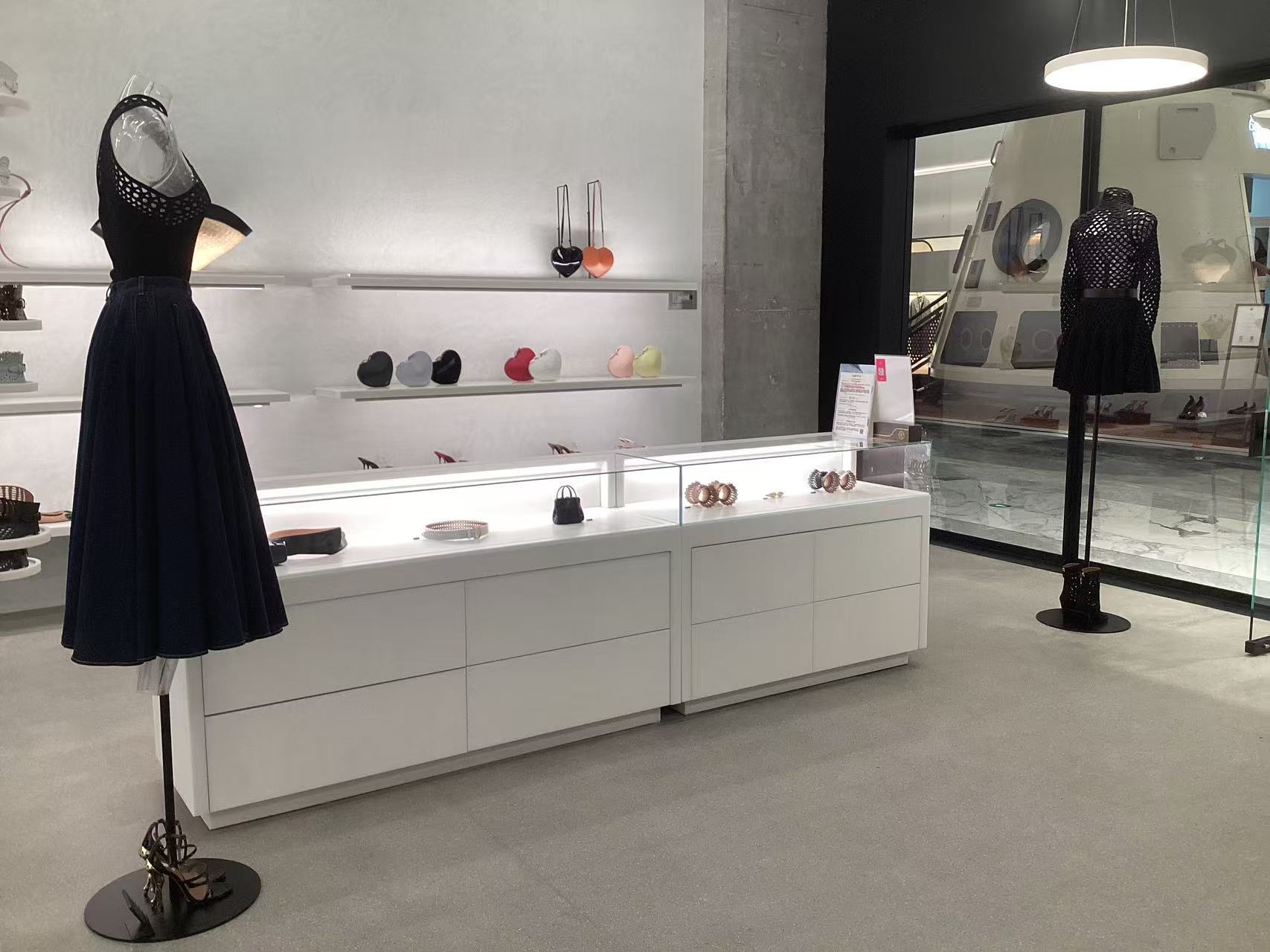 DTC brand boutique with mannequins and glass counter